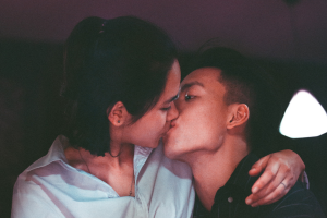 teenage couple (male and female) kissing