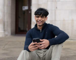 Young person on their phone laughing