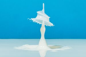 a splash of milky liquid against a bright blue background