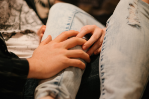 close up of hands on leg