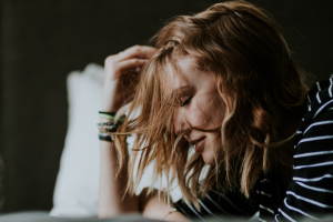 woman looking stressed in bed