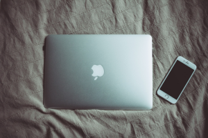 Laptop and phone on bed