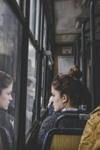 A woman on a bus looking out the window