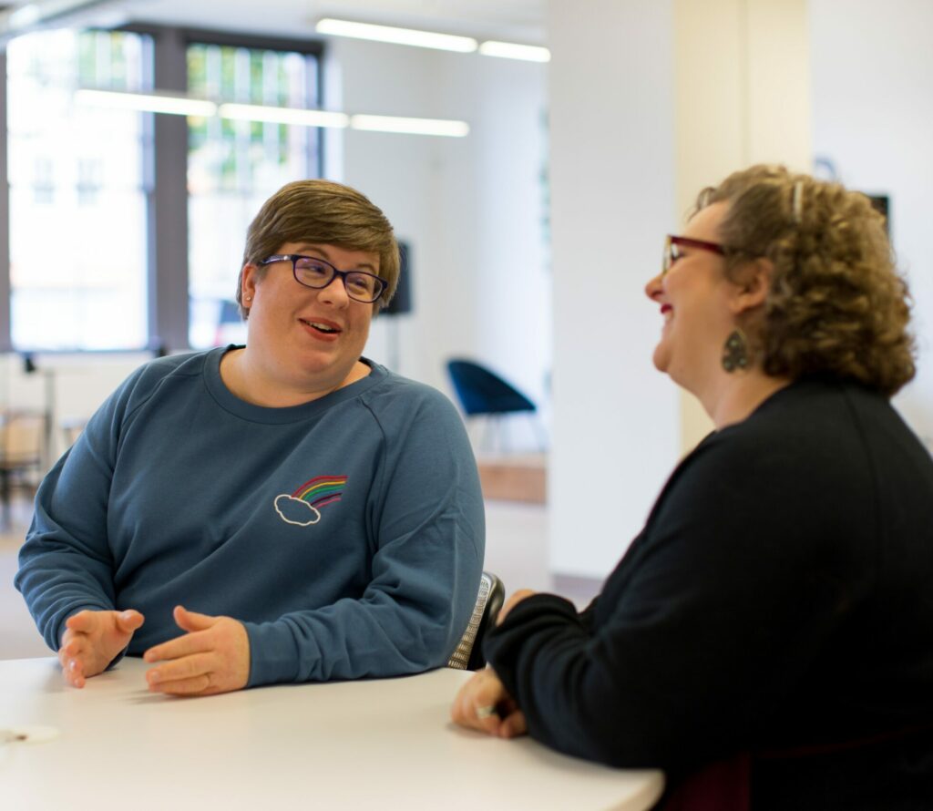 two people talking and laughing
