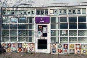 Entrance to Brook Euston with Chalton Street in capitals above the door and a purple Brook logo