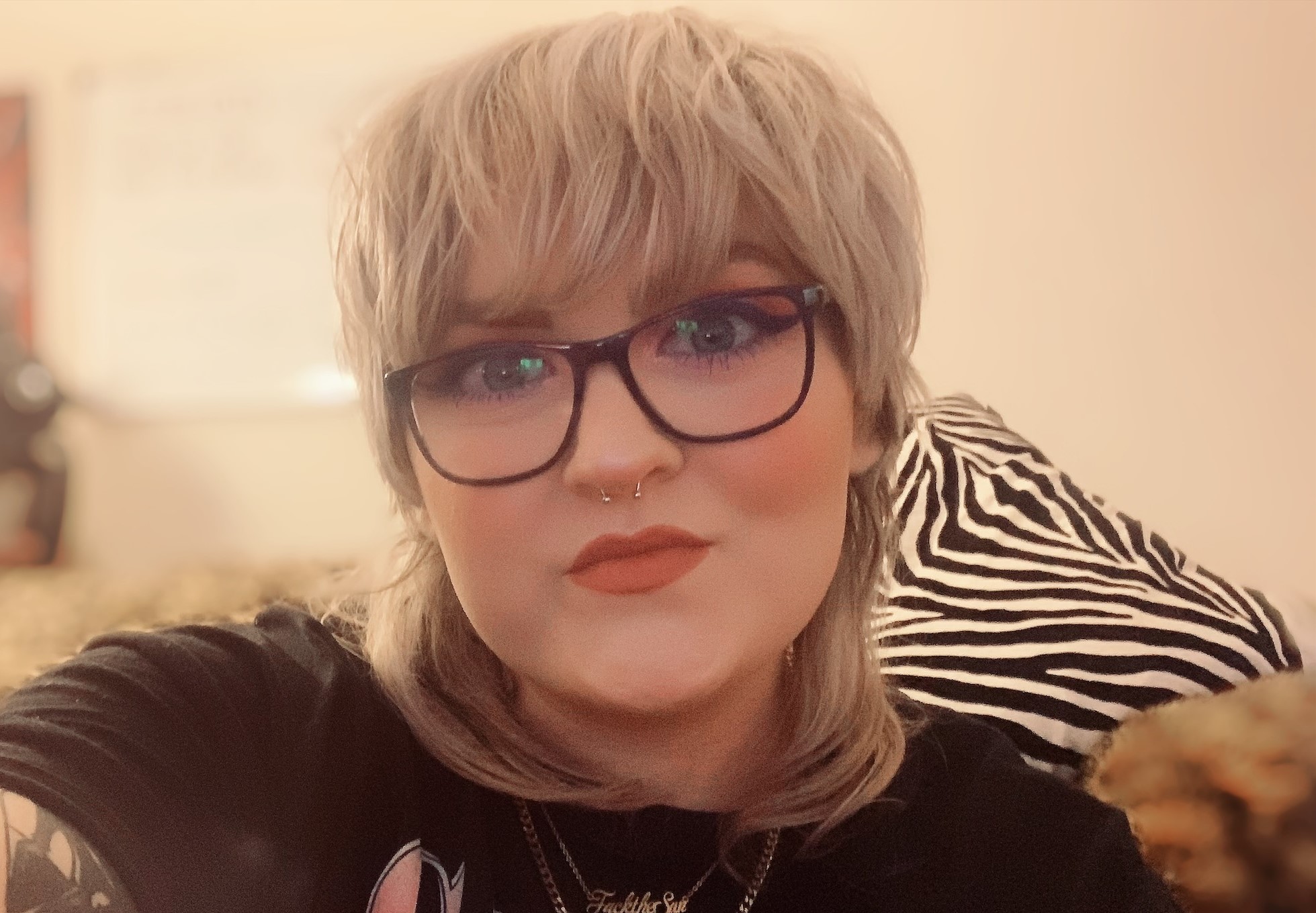 Cassie at home. She wears glasses and has blonde hair