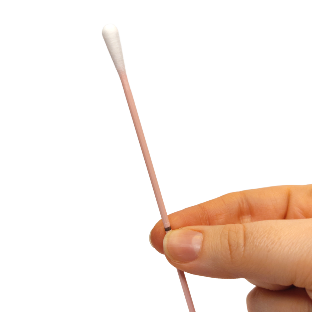 A hand holding the swab at the black line