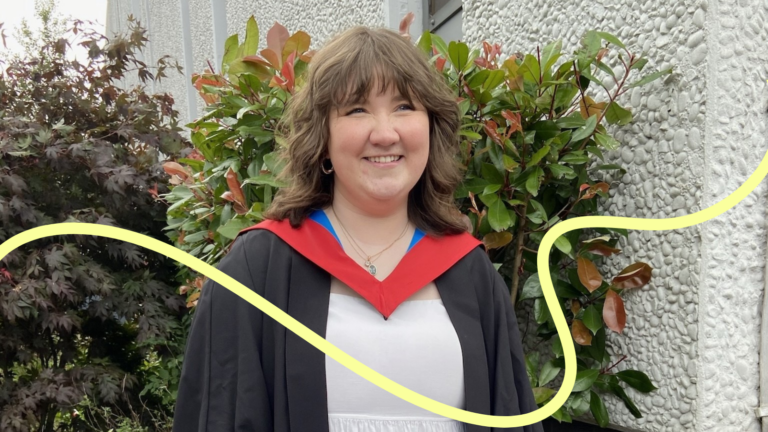 Rachel smiling in her graduation gown