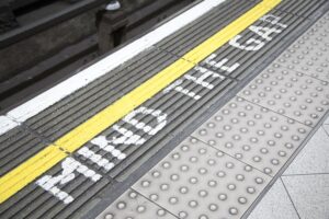 Photo of the 'mind the gap' writing on the floor found at train stations