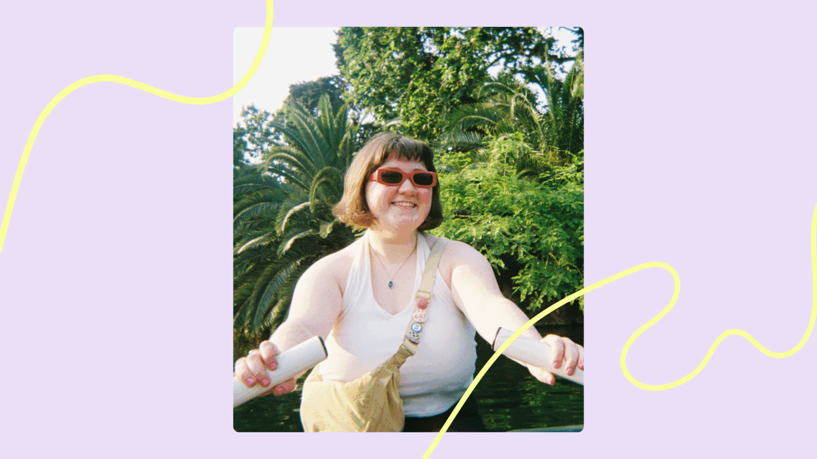 A portrait of a Queer person smiling with sunglasses rowing a boat