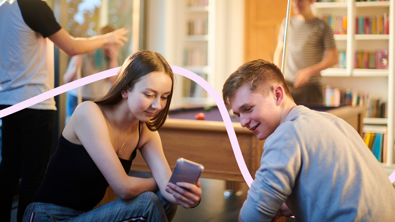Young people on their phones at a youth club