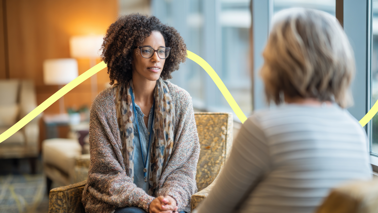 Two women talking one-to-one and supporting each other
