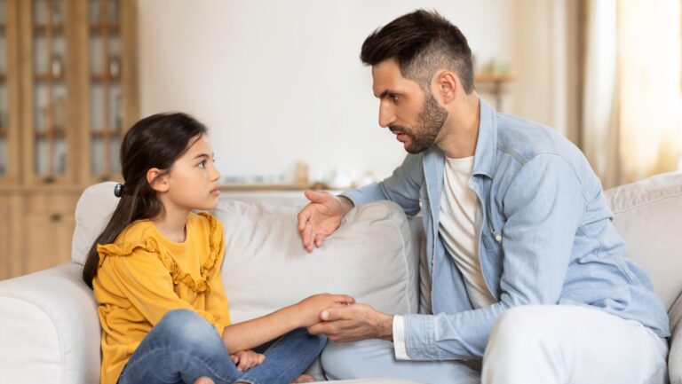 supportive parent talking to child in article on How to answer “Where do babies come from?” at every age