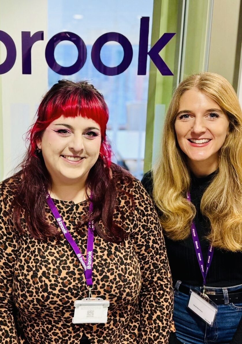 Julie-Anne, Alice and Sarah stood in front of a Brook logo