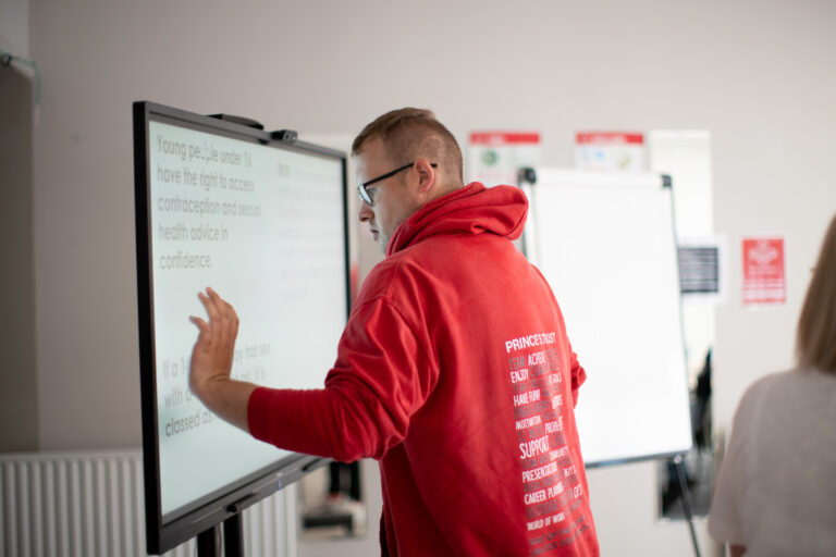 Young person in an RSE lesson in front of whiteboard