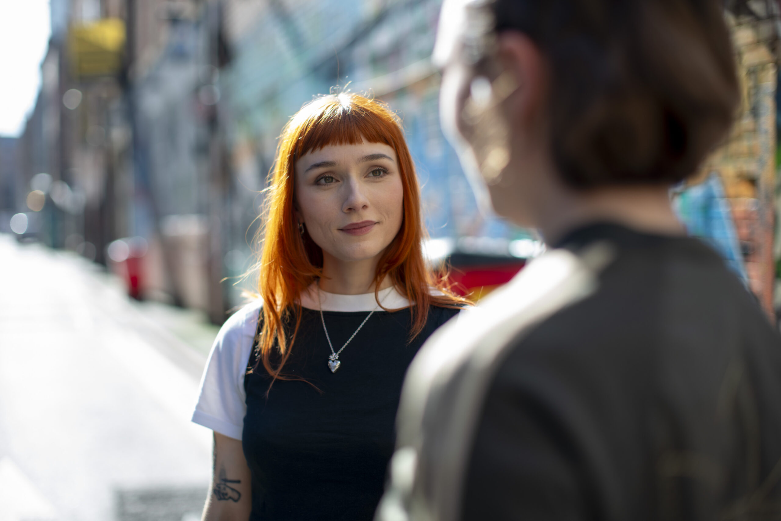 Two young people standing in the street