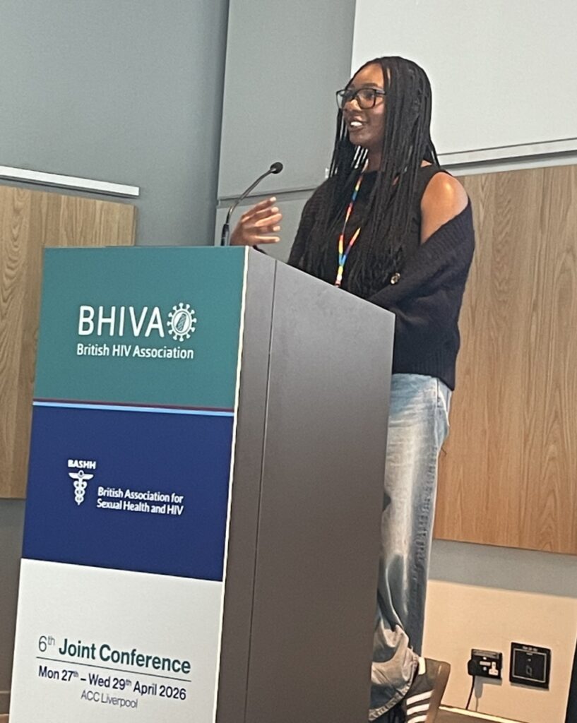 Jade standing behind a podium presenting