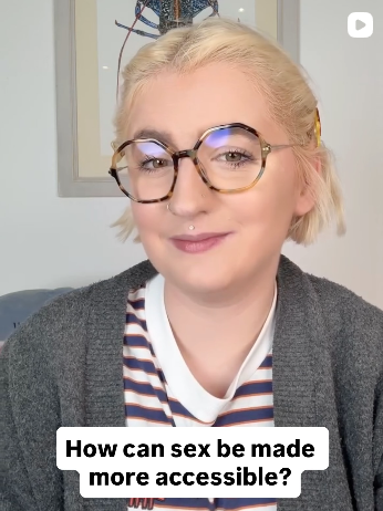 Eliza Rain wearing glasses, a striped shirt, and cardigan with the caption "How can be sex be made more accessible?"