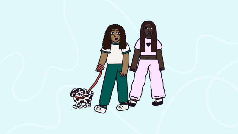 Two people walking a dog