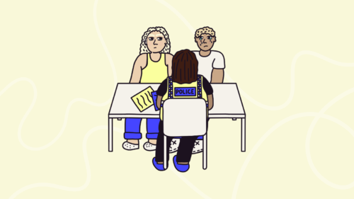 two people sat with a police officer