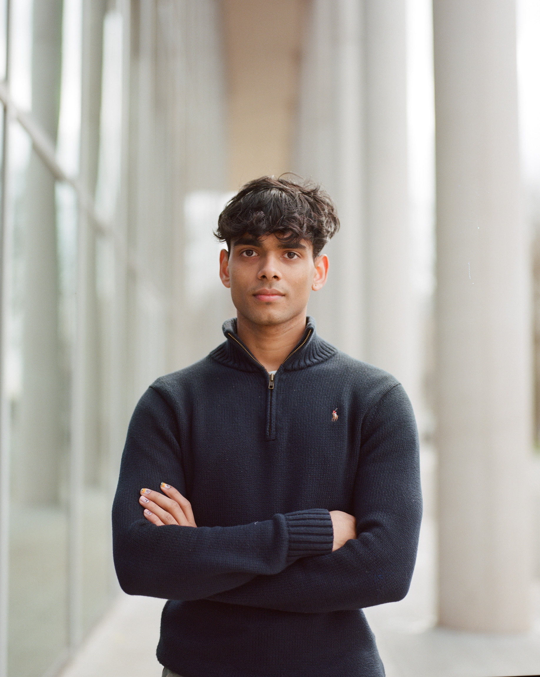 A man stands with his arms crossed
