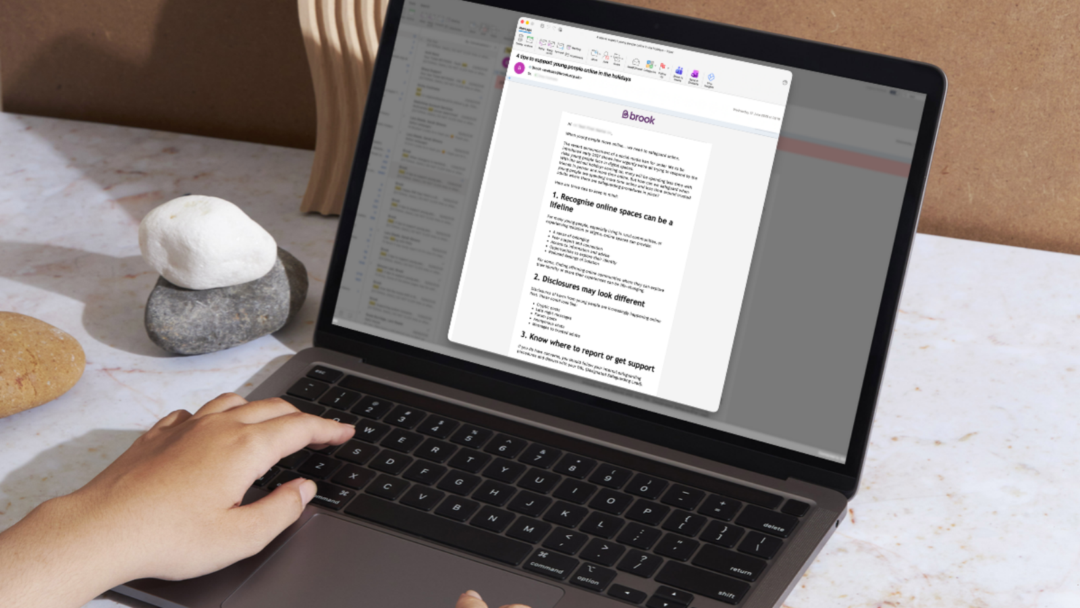 A laptop displaying an email